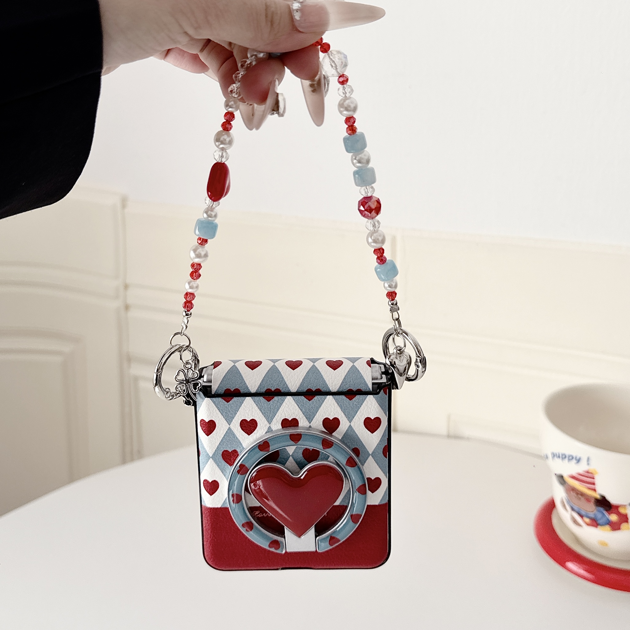 Samsung Galaxy Z Flip 7 slim phone case, featuring a detachable magnetic heart-shaped stand and a beaded hand strap. - Image 10